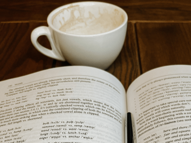 A cozy scene with a cup of coffee and a book resting on a table. Perfect for a relaxing afternoon.